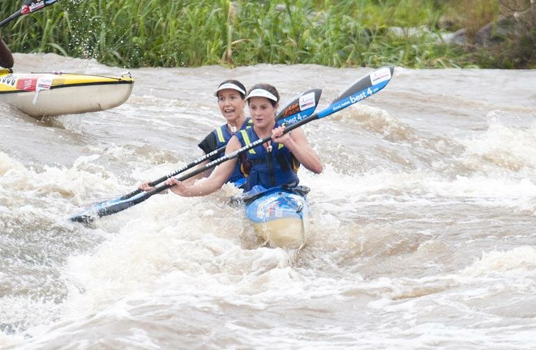 Robyn Kime (front) and Abbey Ulansky en route to their victory in the 2012 Dusi Canoe Marathon. The pair have confirmed they will be back to defend their title in February.