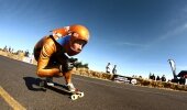 Feet are glued to the board as riders apex the tight, right corner. Blink and you'll miss them.