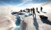 Crossing Melting glacier ice streams and crevasses requires careful navigation during a glacier crossing.