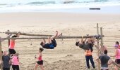 The climbing poles form part of the 'Bucket and spade' challenge, a 500 m stretch of beachfront turned into an obstacle course for the event.