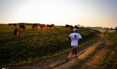 Mdu Zondi makes his way past some very curious onlookers as the sun rises in the backdrop, 