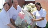 From left: GMSA's Huldah Solomon, Angus Clark and Thanusha Pillay dispose of the waste in the container.