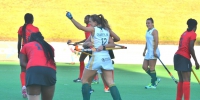 Goalscorer Dirkie Chamberlain (12) is embraced by SA captain Nicolene Terblanche (obscured) as Jade Mayne (27) looks on during the Greenfields Africa Hockey Championships match against Kenya at Randburg Hockey Stadium Thursday.