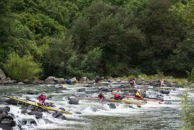 Due to low water levels during the race, many paddlers had to walk their boats through some of the more technical rapids, this one being mKulu rapid on day two.