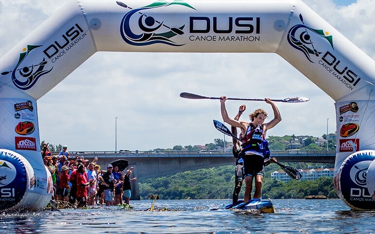 Andy Birkitt and Sibonelo Zondi celebrate winning the 2014 Dusi Canoe Marathon at the designated finish at Blue Lagoon on Day 3.