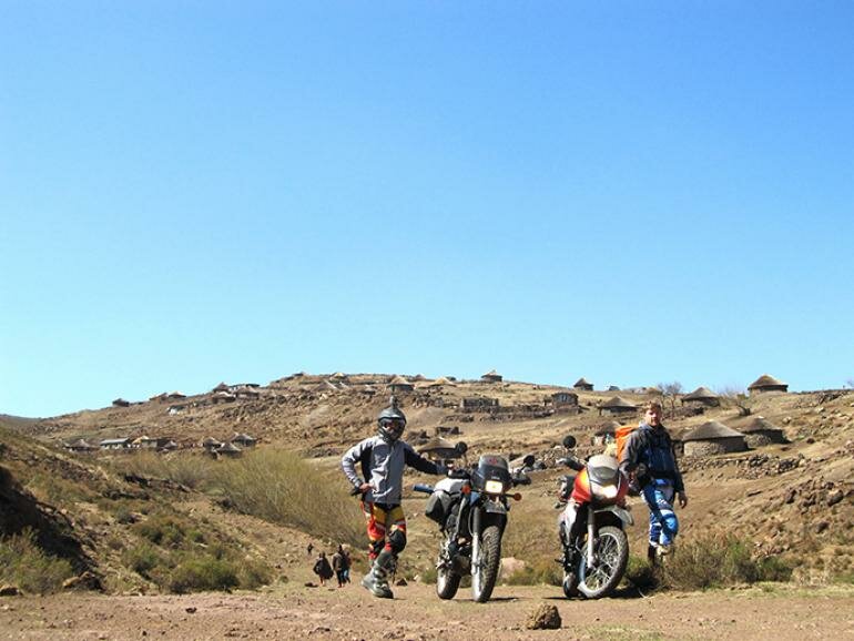 Greg (left) and Ryan (right) stopped in front of a Lesotho village. do it now magazine, doitnow, adventure, lesotho, Thaba–Tseka, Sehlabthebe National Park, off road biking, afriski, motorsports