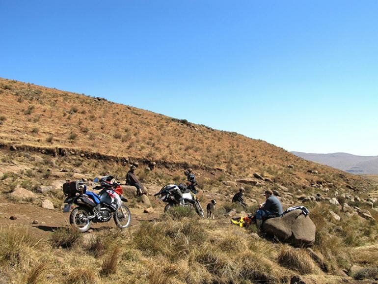 Stopping for a snack with some Basotho sherperds and their dogs. do it now magazine, doitnow, adventure, lesotho, Thaba–Tseka, Sehlabthebe National Park, off road biking, afriski, motorsports