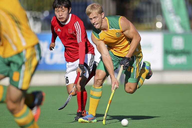 SA midfielder Clint Panther suges upfield as China's Chen Du fades. 